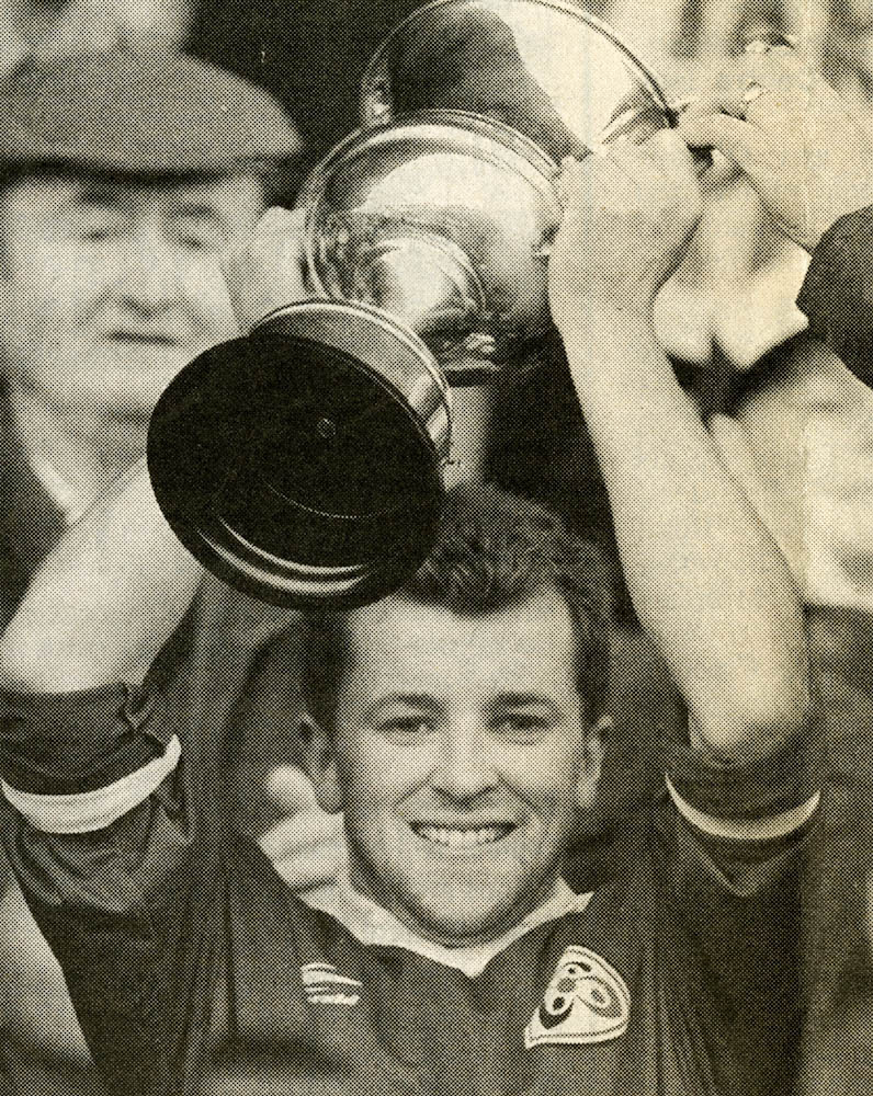 Mark O Connor (capt.) 1996 proudly holds the Munster Club Championship trophy aloft.